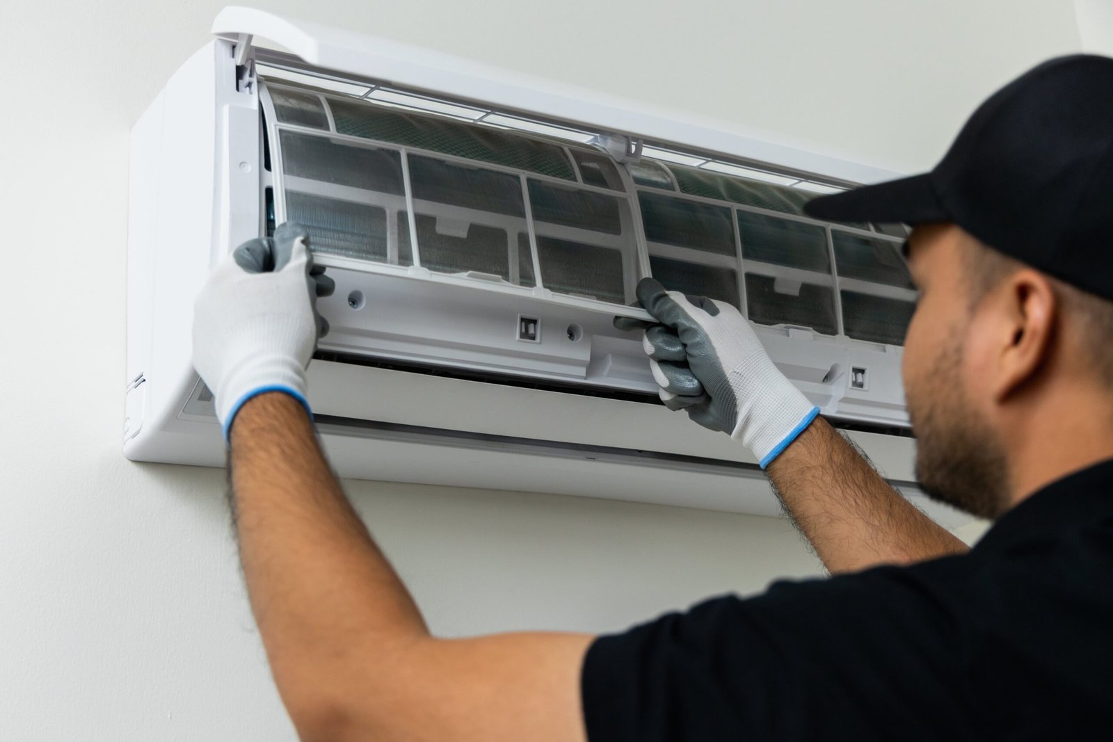 air-conditioner-service-indoors-air-conditioner-cleaning-technician-he-opened-front-cover-took-out-filters-washed-it-he-uniform-wearing-rubber (1)-min